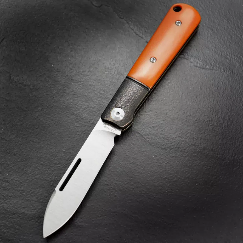 JE made Barlow with handle made of paper Micarta in orange M390 steel